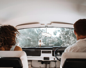 A man driving the car with the instructor